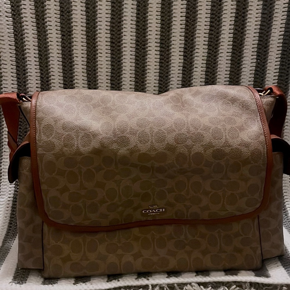 Coach diaper bag. Brown with a burnt orange trim. Used for one year.